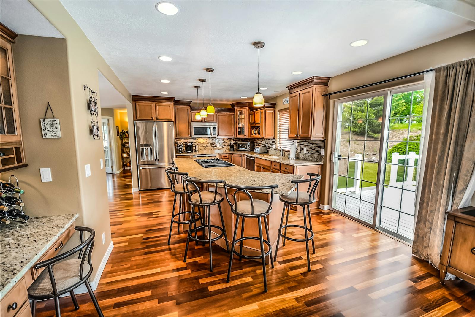 A renovated kitchen with classic cabinetry and warm wood floors
